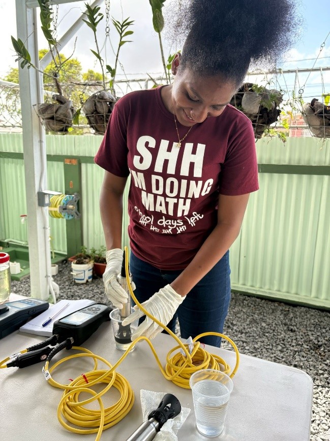 Sasha Bentham Using a Water Testing Meter