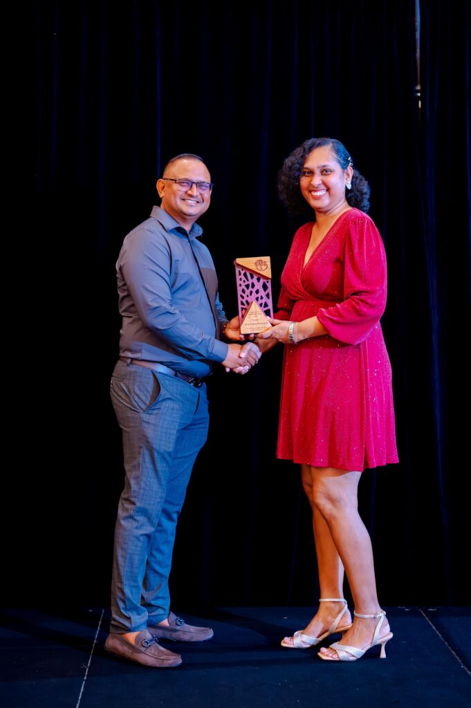 Sharmattie Ramnauth receiving the Punctuality and Commitment Award
